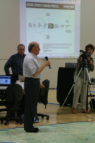 Allan Falconer comments on population issues as Mat Kaplan looks on and Ashley Gardner behind the video camera.