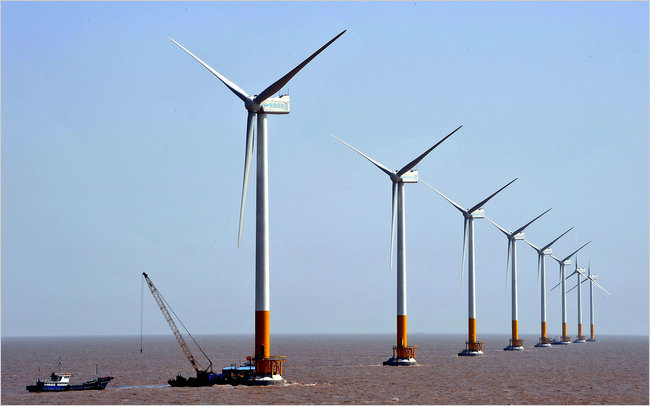 Turbines of the Donghai Bridge Offshore Wind Farm in Shanghai. China invested almost twice as much in renewable energy last year as the United States. Credit Color China Photo, Via Associated Press