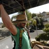 David Miller of SolarCity carries a photovoltaic panel ready to be installed on a home in Torrey Hills. 